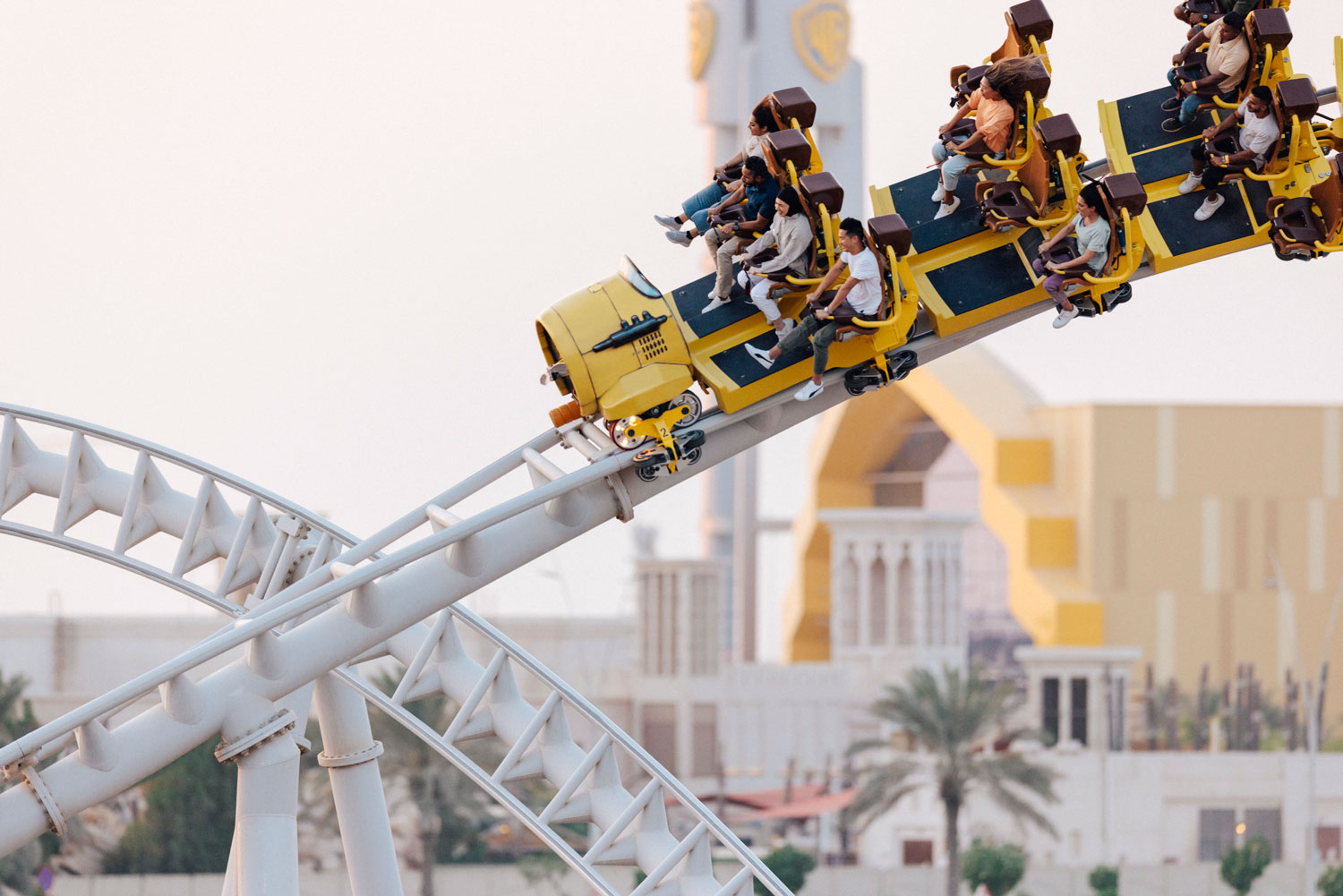 Thrill-seekers enjoying an exciting roller coaster ride at a theme park in Abu Dhabi.